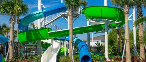 A water park with multiple slides and a pool.
