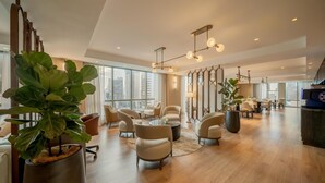 A spacious hotel lobby with modern furniture, large windows, and a city view. - Hyatt Regency Panama City (Panama City)