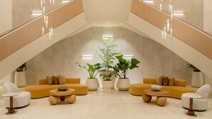 A modern interior with a central seating area, potted plants, and a staircase. - Hyatt Regency Panama City (Panama City)