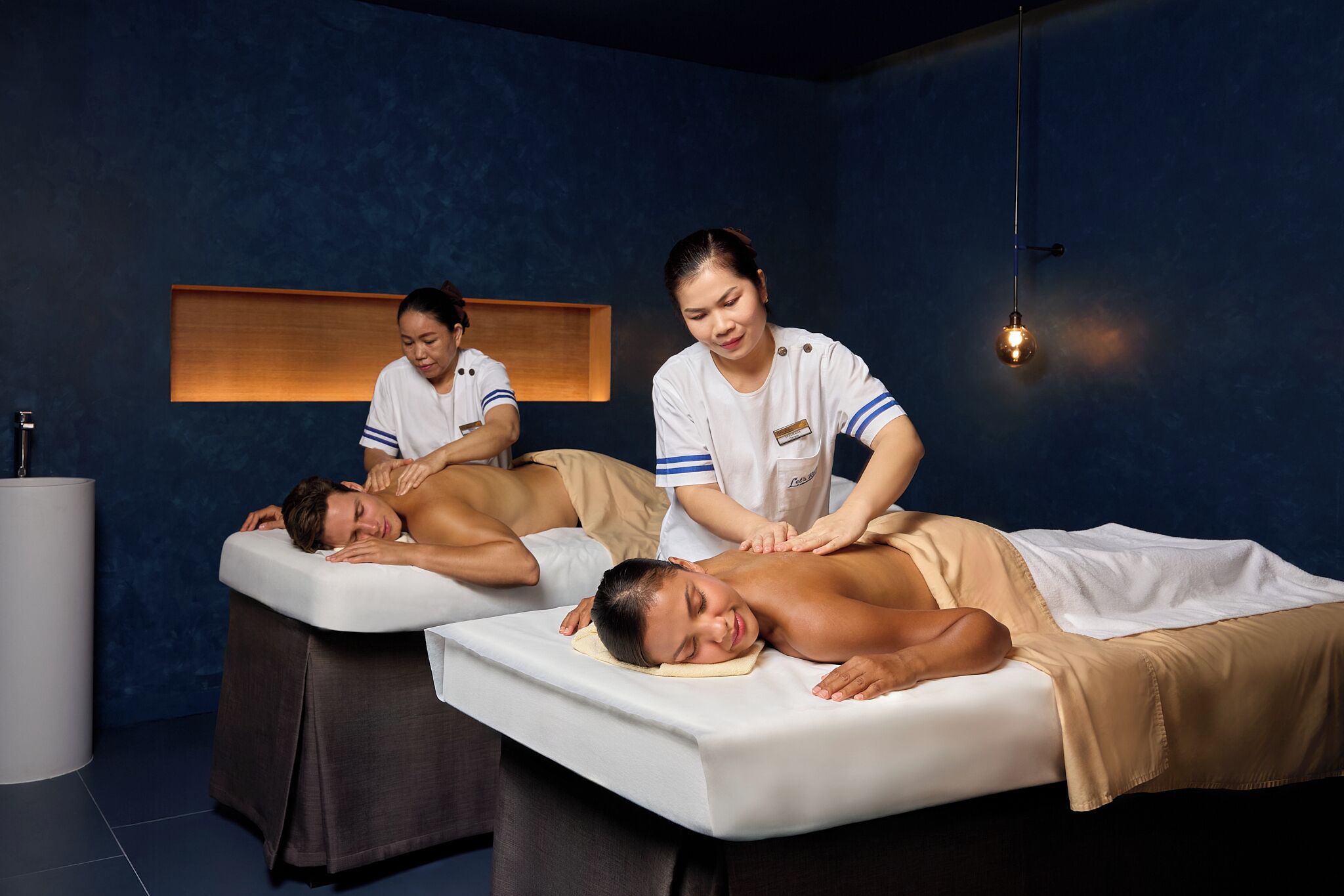 A massage therapy room with two clients receiving treatments.
