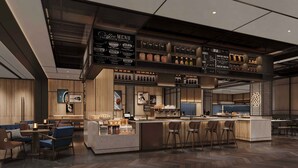 Una cafetería moderna con barra, asientos y un menú.
