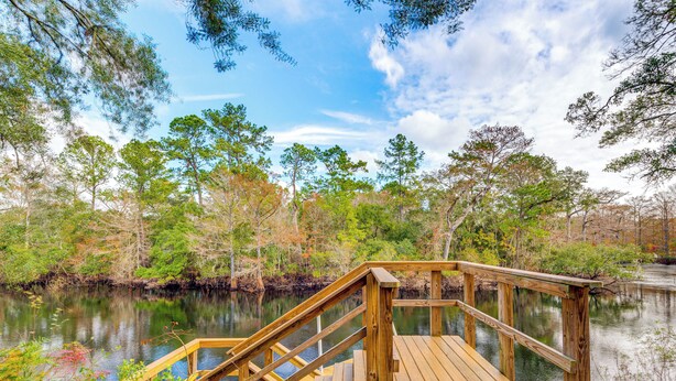 A wooden dock extending over a calm body of water surrounded by trees. - ‘Bovee’s Riverhouse’ Dunnellon Family Getaway! (Dunnellon)