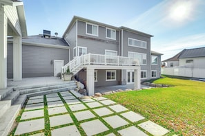 A two-story house with a covered porch and a stone pathway leading to the entrance. - Private Pool & Hot Tub: Luxe Unit Near UTA Train! (American Fork)