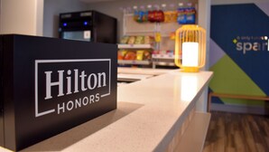 A hotel reception desk with a sign reading "Hilton Honors". - Spark By Hilton Albuquerque North I-25 (Albuquerque)