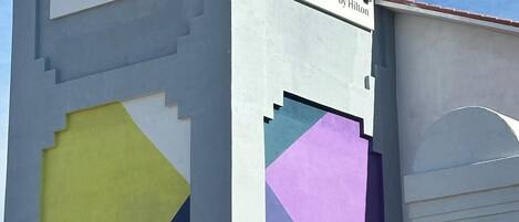 A hotel sign with the name 'spark by Hilton' and a geometric design on the facade.