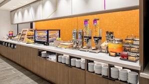 A buffet setup with various food items and containers, including a coffee station and a section labeled "OATMEAL". - Home2 Suites By Hilton Woodland Sacramento (Woodland)
