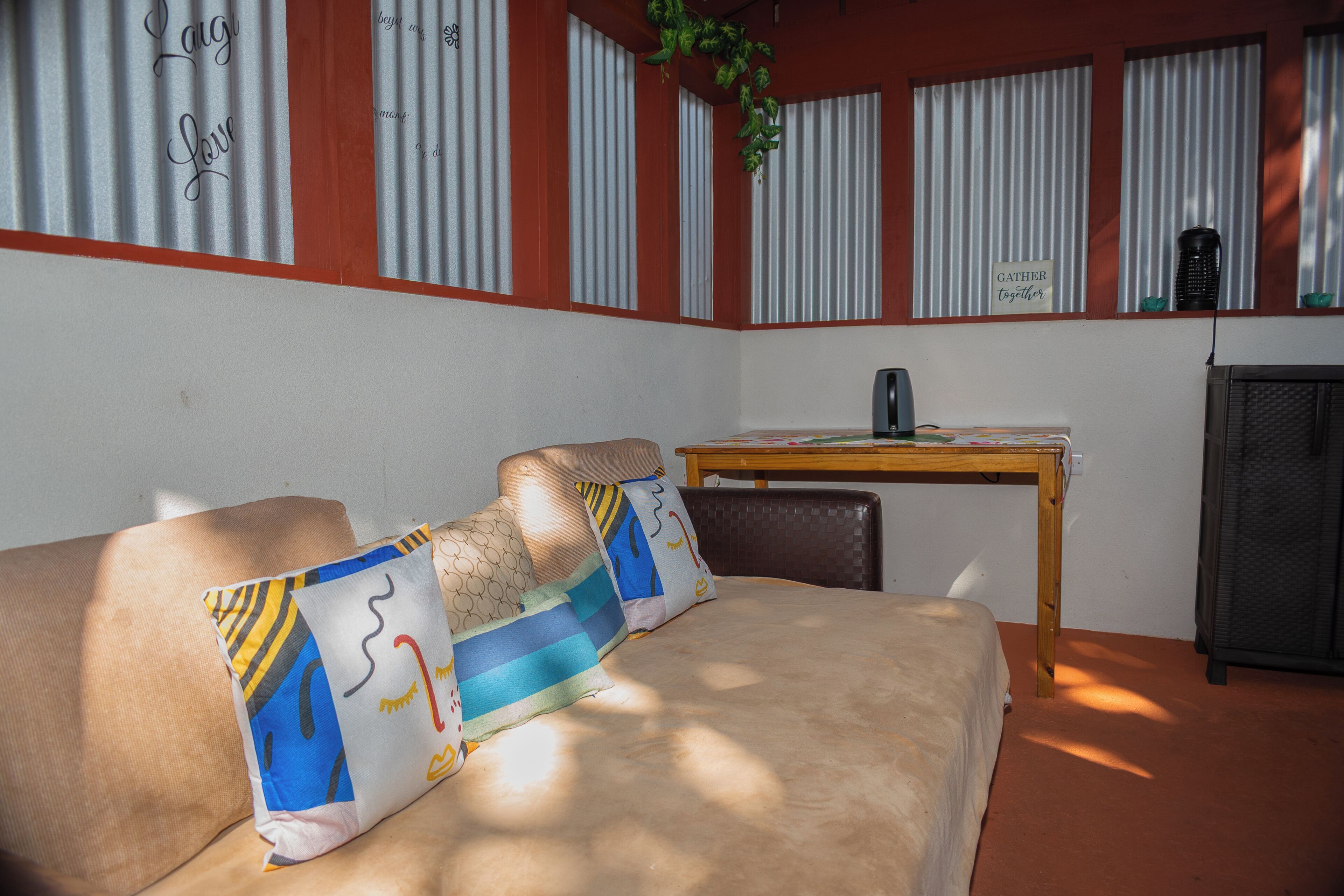 A room with a bed, a table, and a radiator.