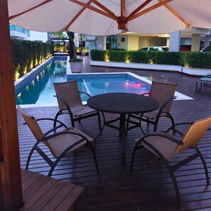 Relax by the pool surrounded by lush greenery and enjoy a refreshing dip in the hot tub.