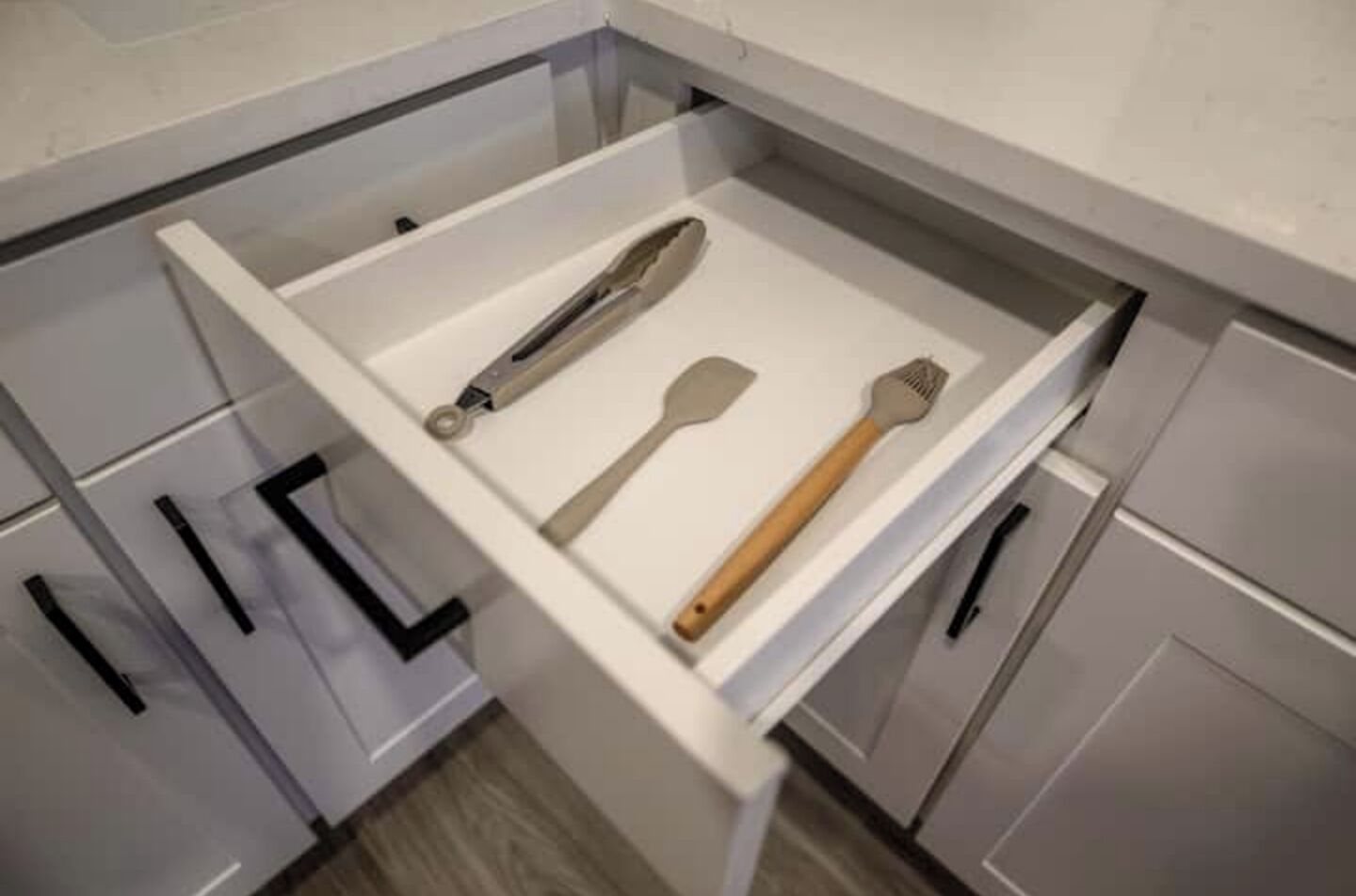 A kitchen drawer with utensils.