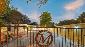 A gated entrance to a property with a prominent 'MOORE'S VILLAS' sign. - Austin Gated Oasis | 4BR | Sleeps 8 | Fire Pit (Austin)