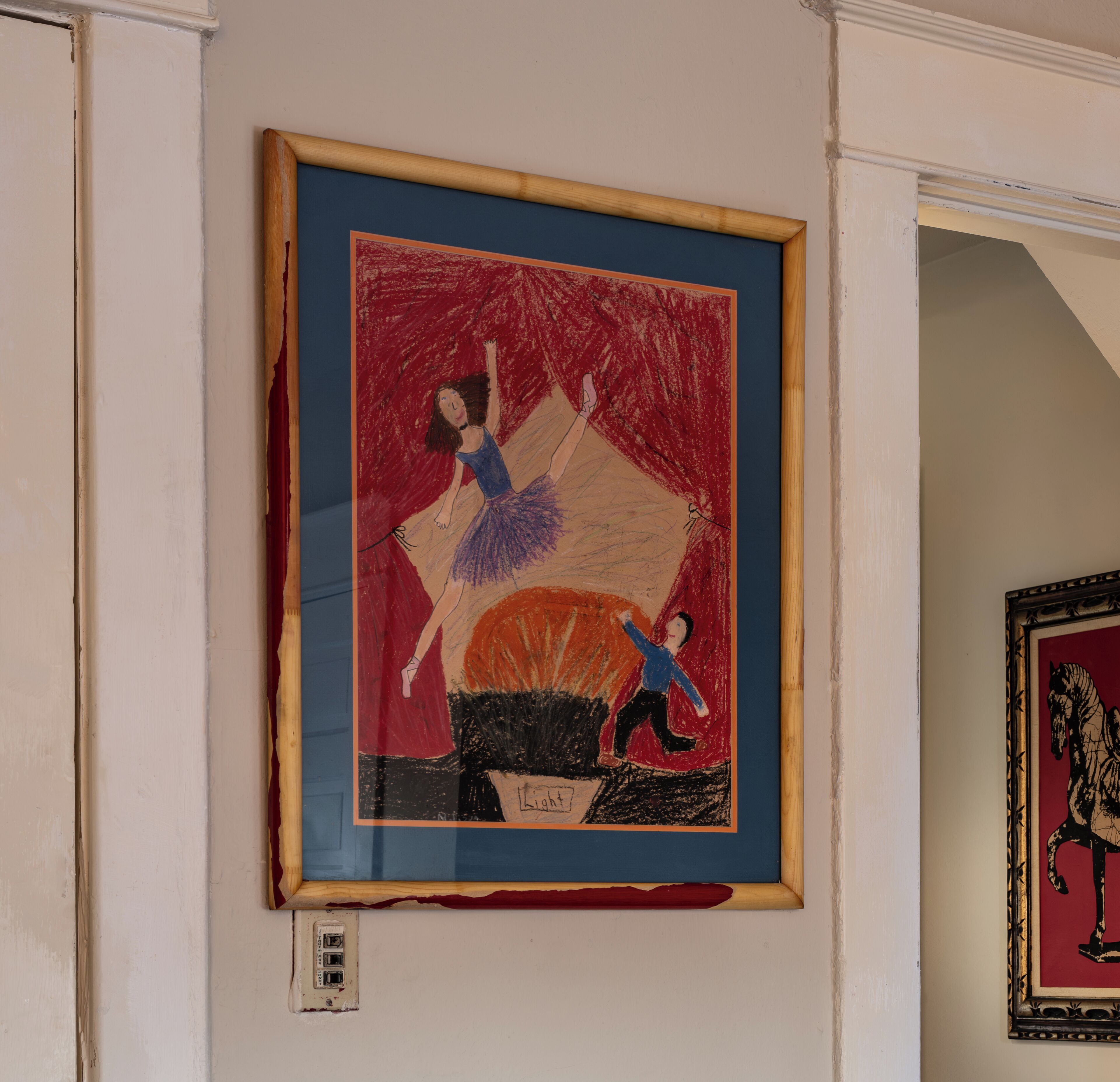 A framed artwork on a wall.