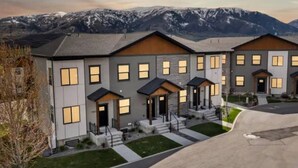 A modern multi-story residential building with a symmetrical facade, large windows, and a flat roof. - Powder Mountain Ski Retreat, an art-inspired townhome in the heart of Eden (Eden)