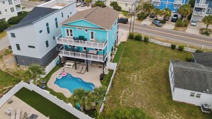 A two-story house with a balcony, a swimming pool, and a view of the beach. - The Turquoise Turtle -Private Pool, Hot Tub, Ocean View, 2nd Row, 4BR, Kids Area (Carolina Beach)