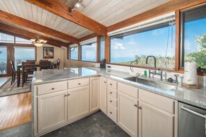 A kitchen with a large island, wooden cabinets, and a view of the outdoors. - Pet-Friendly 5BR Home! Spectacular Mtn Views, Hot Tub, 5 min to Beech Ski (Beech Mountain)