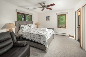 A bedroom with a bed, two bedside tables, a ceiling fan, and two windows. - Pet-Friendly 5BR Home! Spectacular Mtn Views, Hot Tub, 5 min to Beech Ski (Beech Mountain)