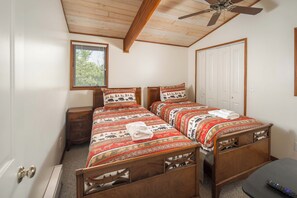 A bedroom with two wooden beds, a ceiling fan, a window with blinds, and a door. - Pet-Friendly 5BR Home! Spectacular Mtn Views, Hot Tub, 5 min to Beech Ski (Beech Mountain)