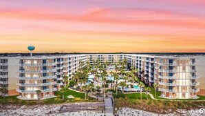 A multi-story hotel with a central courtyard, outdoor pool, and beach access. - Waterscape B105 ~ 2BR Ground Floor ~ Gulf Views! (Fort Walton Beach)