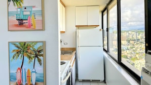 A narrow kitchen with a view of a cityscape. - Waikiki Studio with Stunning Views! (Honolulu)