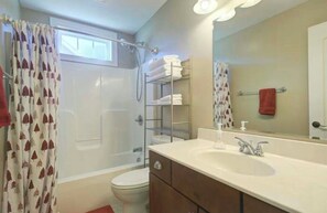Un baño con ducha, inodoro y lavamanos.
