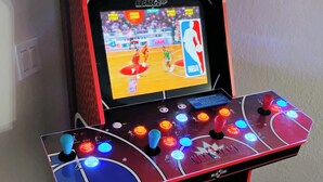 An arcade machine with an NBA Jam Tournament Edition game, featuring a joystick and multiple buttons.