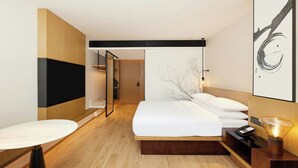 A modern hotel room with a large bed, a flat-screen TV mounted on the wall, a bedside table, and a lamp. - Fairfield by Marriott Haikou Meilan (Haikou)