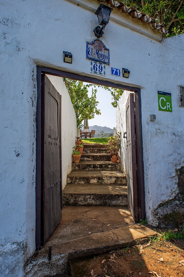 A narrow stairway leading to a door with a sign above it.