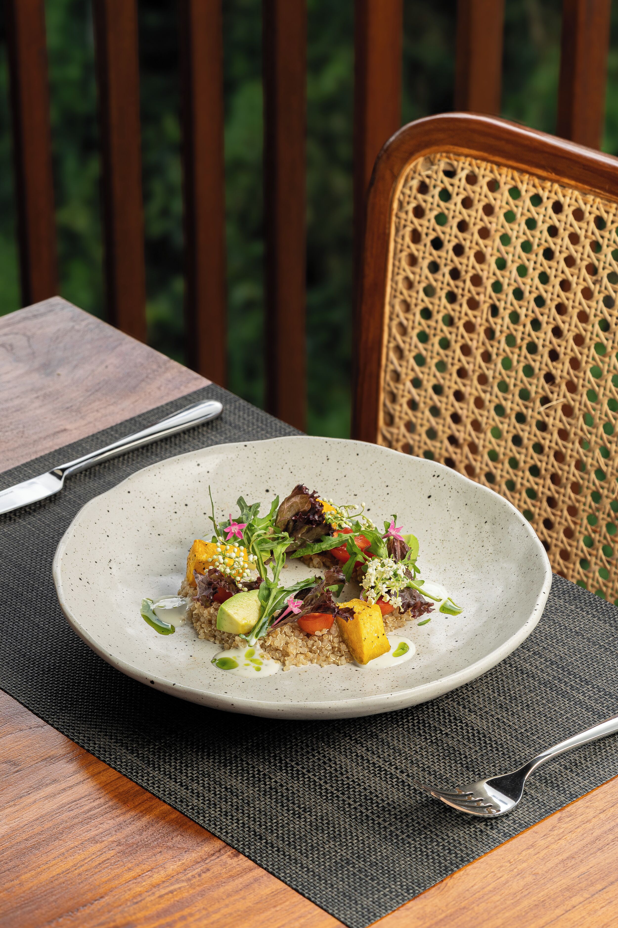 A plate of food on a table with a fork and knife beside it.