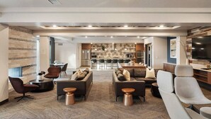 A modern living room with a sofa set, a coffee table, and a TV.