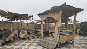 A bamboo structure with a checkered floor, surrounded by bamboo materials. - HOTEL VCR INN (New Delhi)