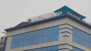 A hotel with a modern design, featuring large glass windows and a prominent sign on the roof. - HOTEL VCR INN (New Delhi)