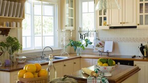 A kitchen with a sink, a fruit bowl, and a rolling pin on the counter. - Middleton House Maleny.  Picture perfect country house for small gatherings. (Witta)