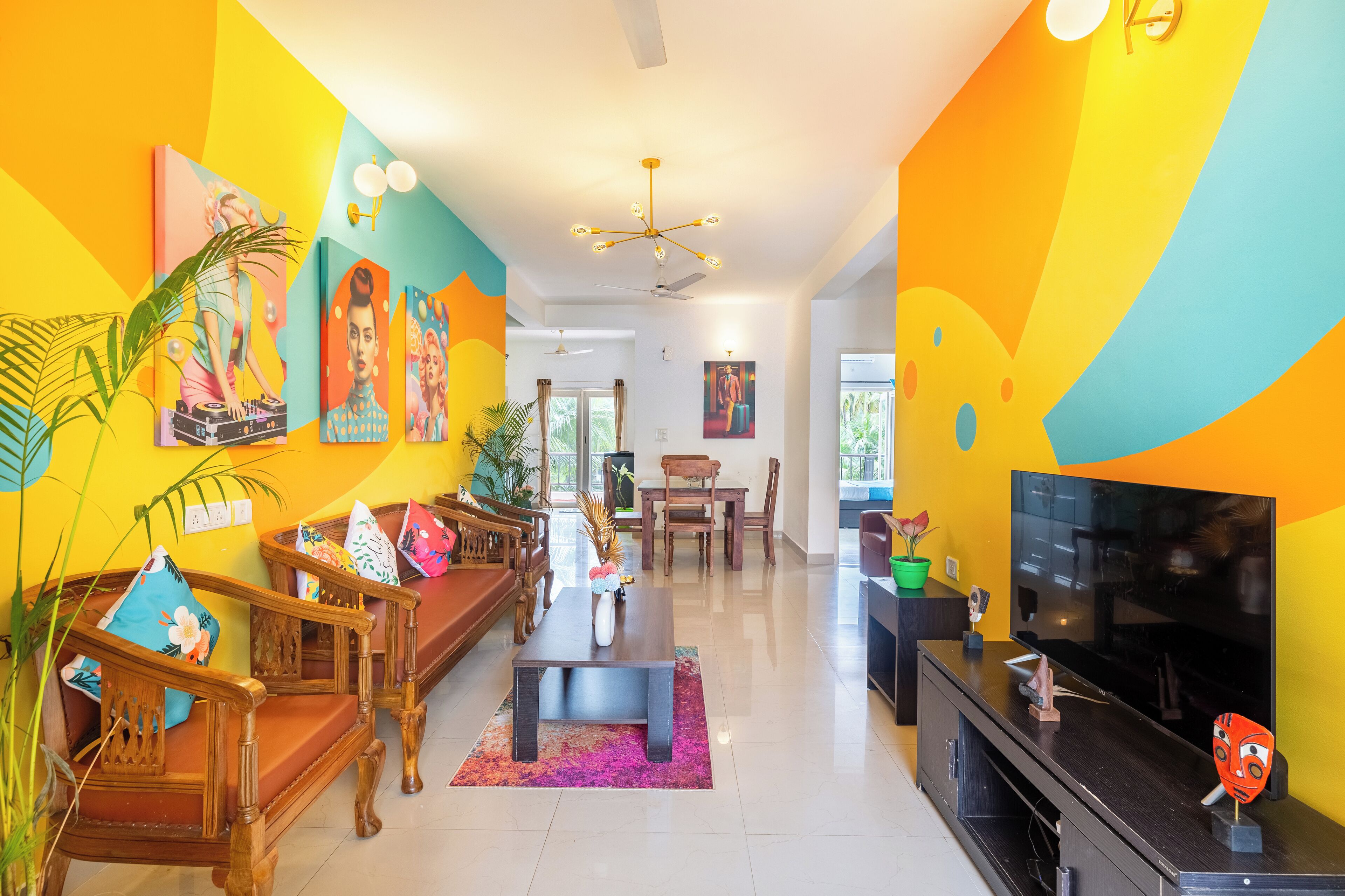 A brightly colored living room with a sofa, coffee table, and TV stand.