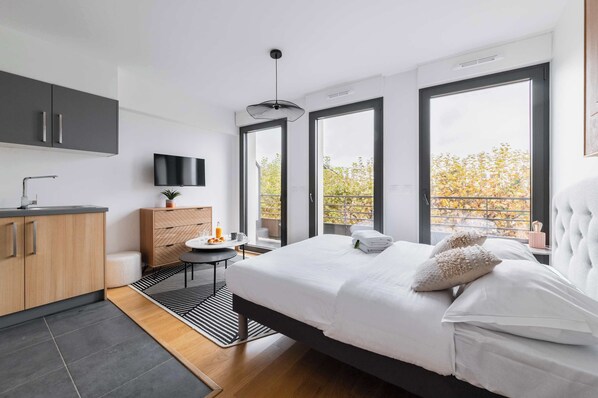 Desk, iron/ironing board, bed sheets