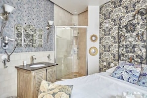 A bathroom with a shower, a sink, and a mirror.