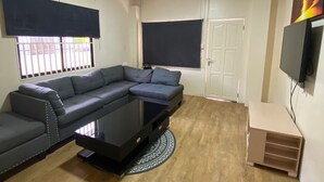Deluxe Apartment, Kitchen | Living area | 55-inch flat-screen TV with cable channels, TV, Netflix