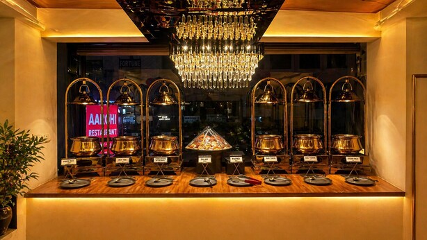 A buffet setup with labeled food stations including rice, vegetables, salads, papad, dal tandoor, and steam rice. - Shyama inn by Rivlet  (New Delhi)