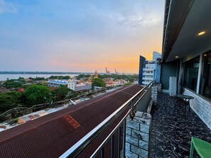 A balcony with a view of a cityscape, including buildings and a river. - Diamond Lake Hotel KTV&Dancing Bar (Yangon)