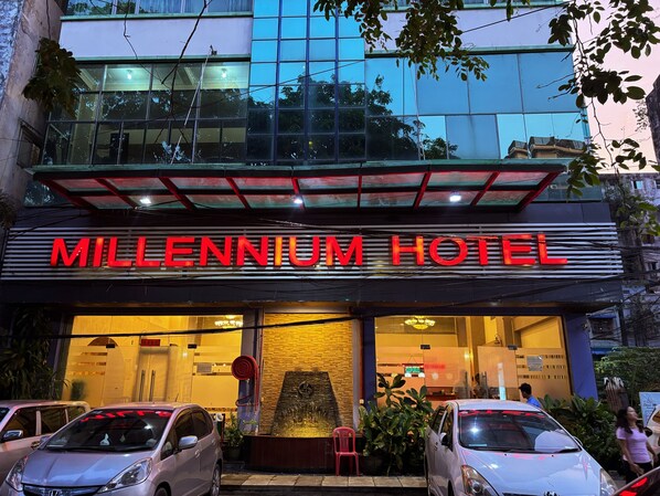 The exterior of the Millennium Hotel with a prominent sign, a glass facade, and a red awning. - Diamond Lake Hotel KTV&Dancing Bar (Yangon)