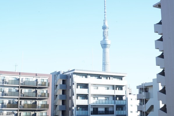 A modern building with multiple balconies and a tower in the background. - softlight inn Asakusa Tokyo (Tokyo)