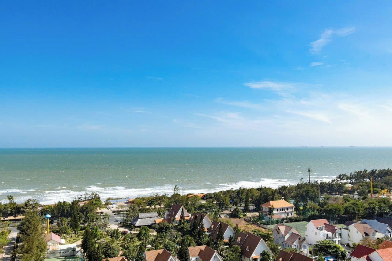 A coastal residential area with houses and a view of the ocean.