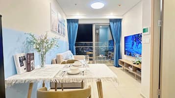Apartment, 1 Bedroom, Balcony, City View | Living area | Flat-screen TV, ping pong, pay films