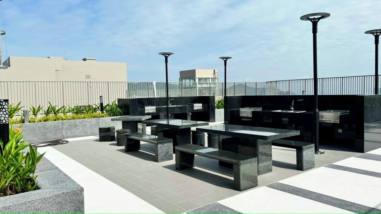 An outdoor patio area with modern seating arrangements and solar lighting.