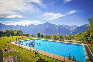 A swimming pool with a view of mountains in the background.