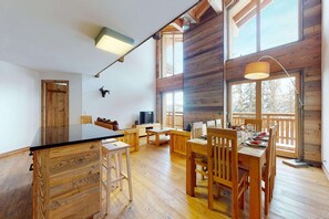 Cozy living area with a large dining table, TV, and cabinet.