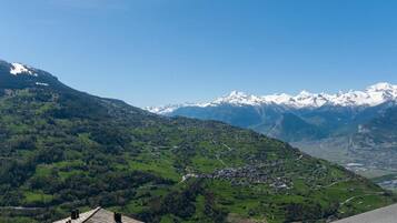 A mountainous landscape with a village nestled in the valley.