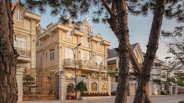 A historic building with ornate balconies and a gated entrance. - The One Da Lat Hotel (Xuan Huong - Da Lat)