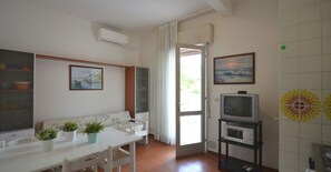 TV - Cozy flat with balcony in a building with lift close to the beach (Bibione)