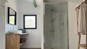 A modern bathroom with a glass-enclosed shower, a wooden vanity, a window, and a towel rack. - Laguillotte- 3 bedrooms (Seignosse)