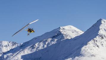 Un helicóptero volando sobre una montaña nevada.
