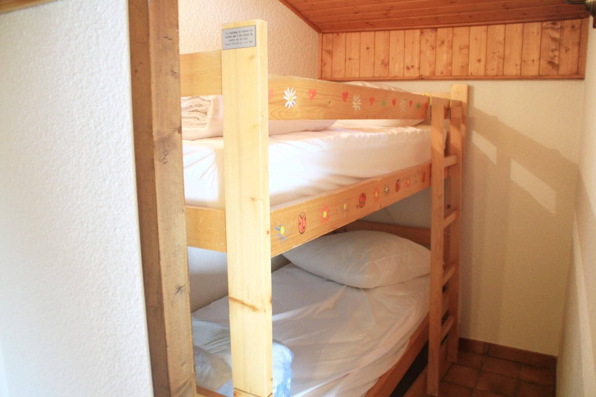 A bunk bed with a wooden frame and a sign on the side.